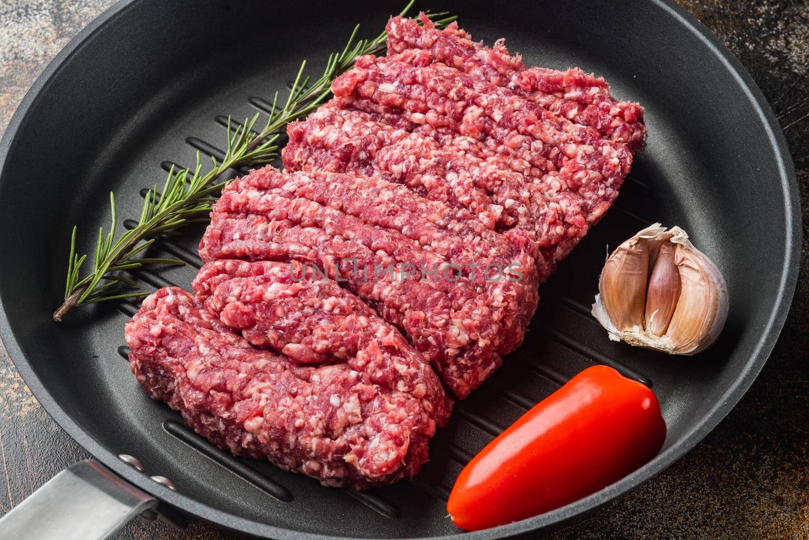 Fresh minced meat, ground beef, on old dark rustic background