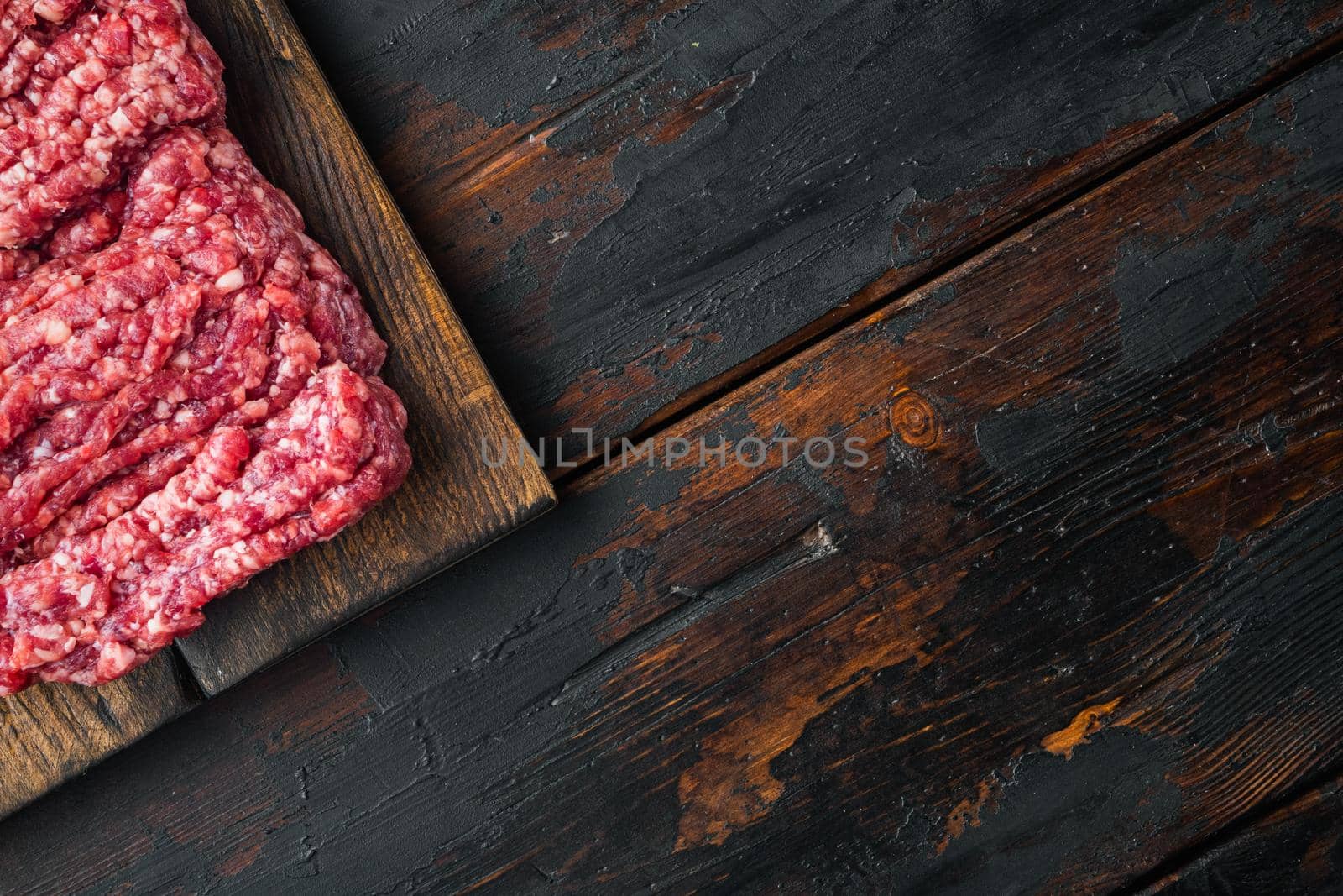 Mince. Ground meat with ingredients for cooking, on old dark wooden table background, top view flat lay with copy space for text