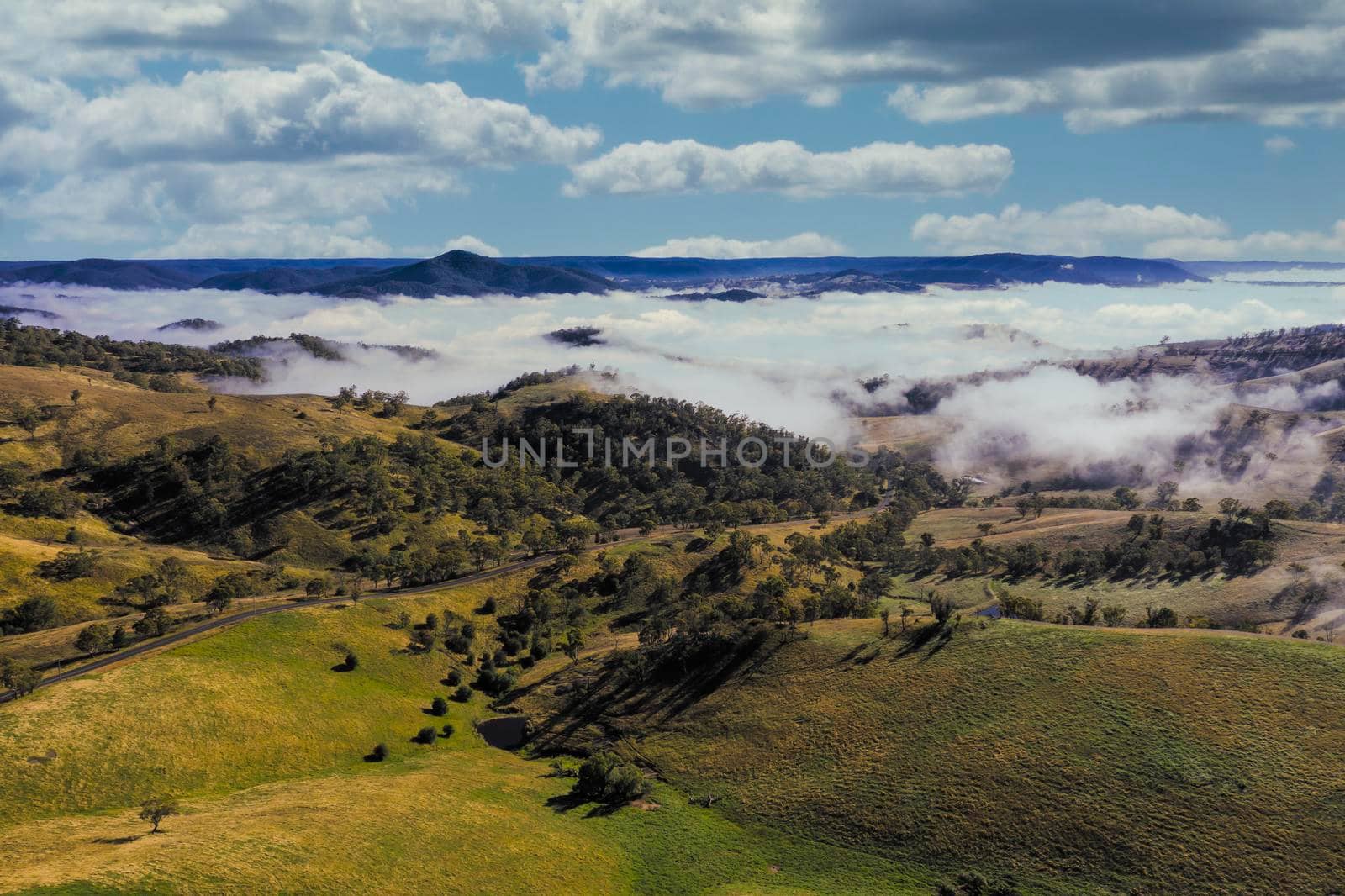 Aerial view of low-level clouds in a large green valley in the Central Tablelands in regional New South Wales Australia