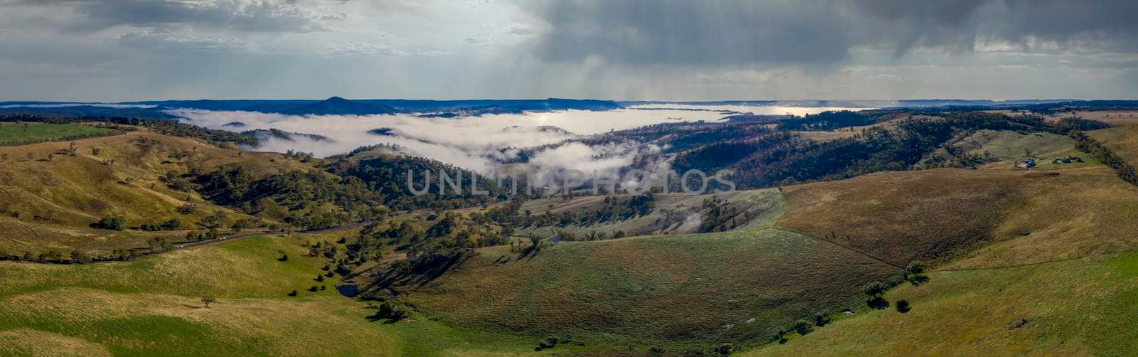 Aerial view of low-level clouds in a large green valley in the Central Tablelands in regional New South Wales Australia