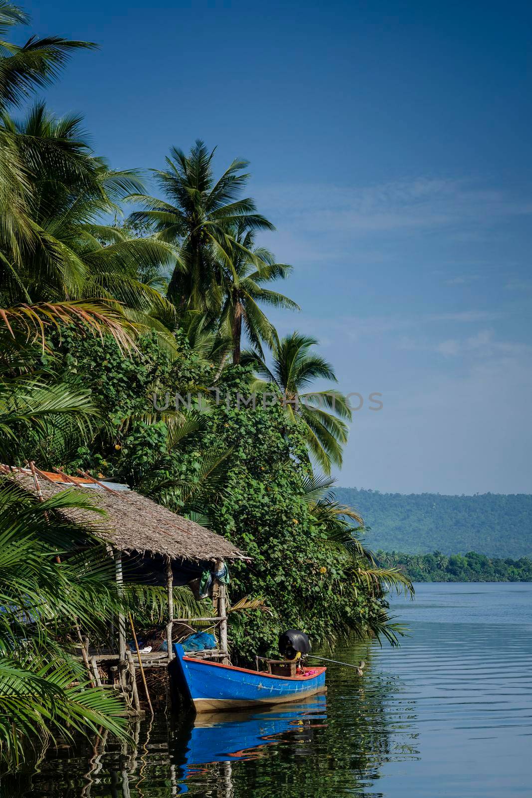 boat and jungle hut on the tatai river in cambodia by jackmalipan