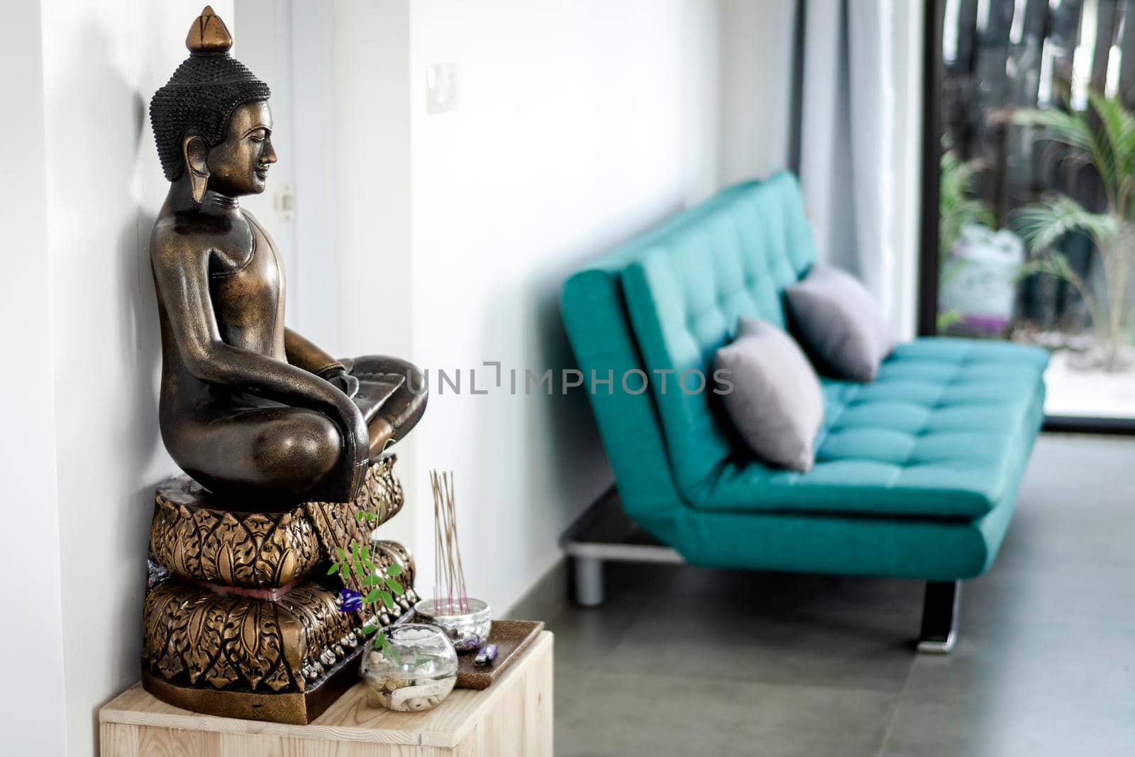 bronze buddha statue interior design detail in modern asian home living room