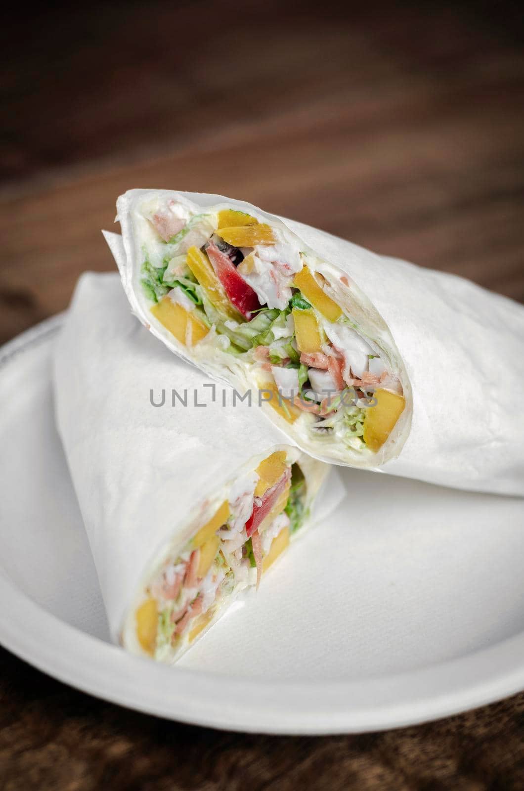 crab mayonnaise and salad wrap on wooden table background