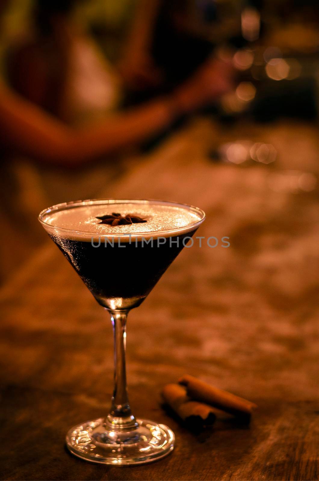 espresso martini cocktail drink in cozy dark bar interior by jackmalipan