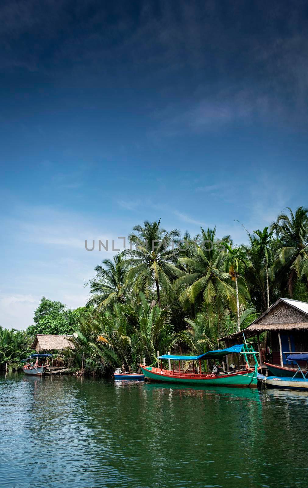 traditional jungle ferry boat at pier on tatai river in cambodia