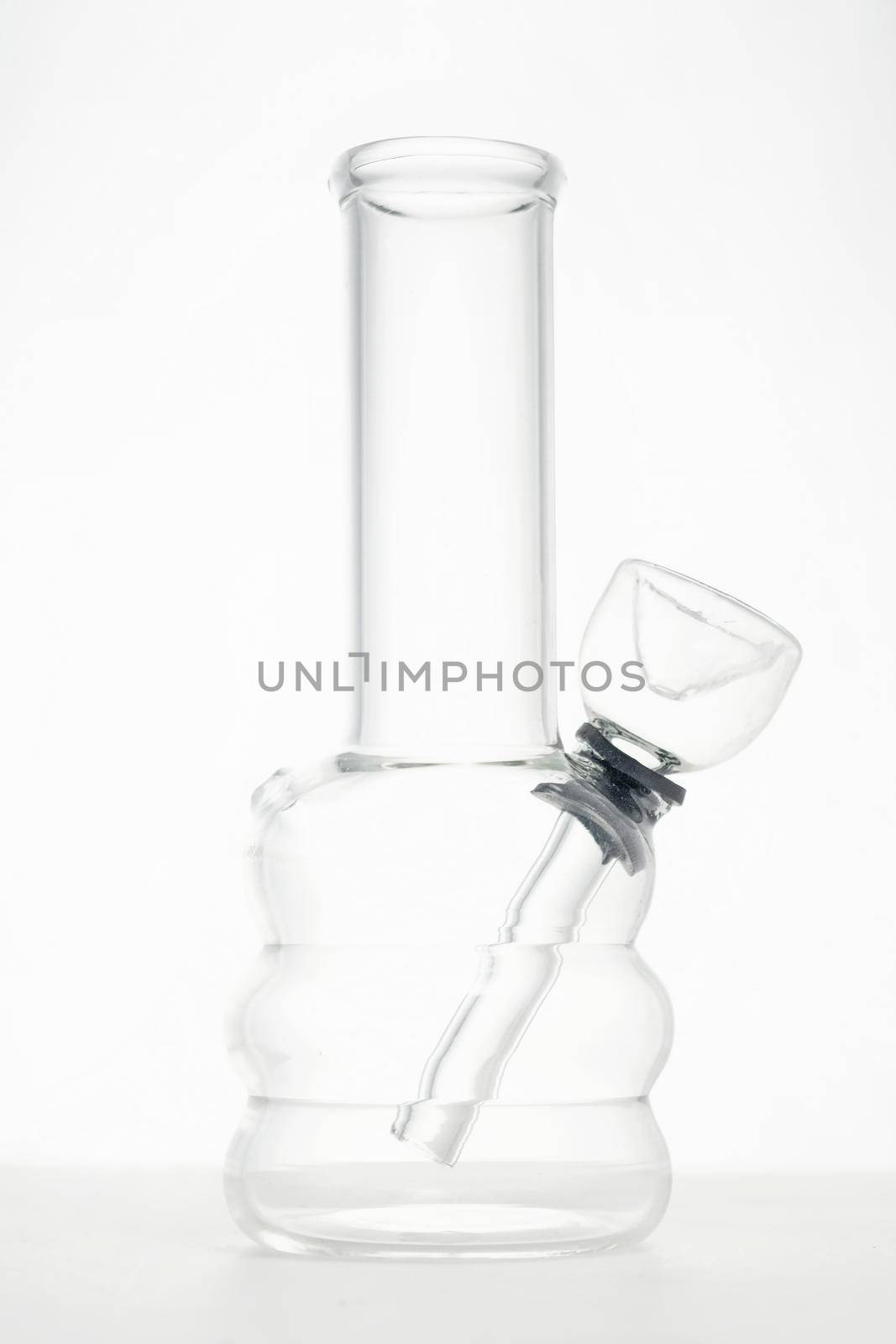 clear glass water bong pipe for smoking medical marijuana or cannabis in white studio background