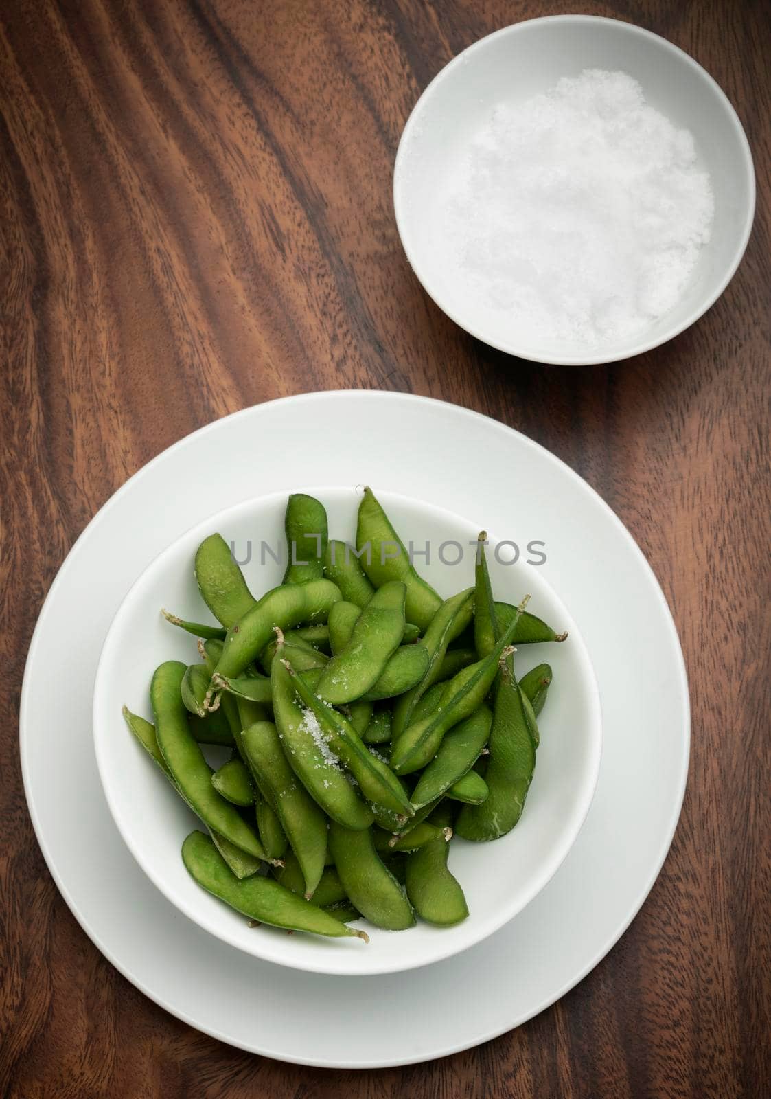 edamame beans snack in bowl on table with sea salt by jackmalipan