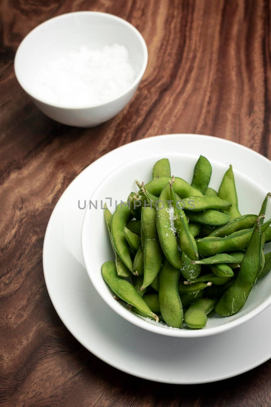 organic edamame beans snack in bowl on table with sea salt