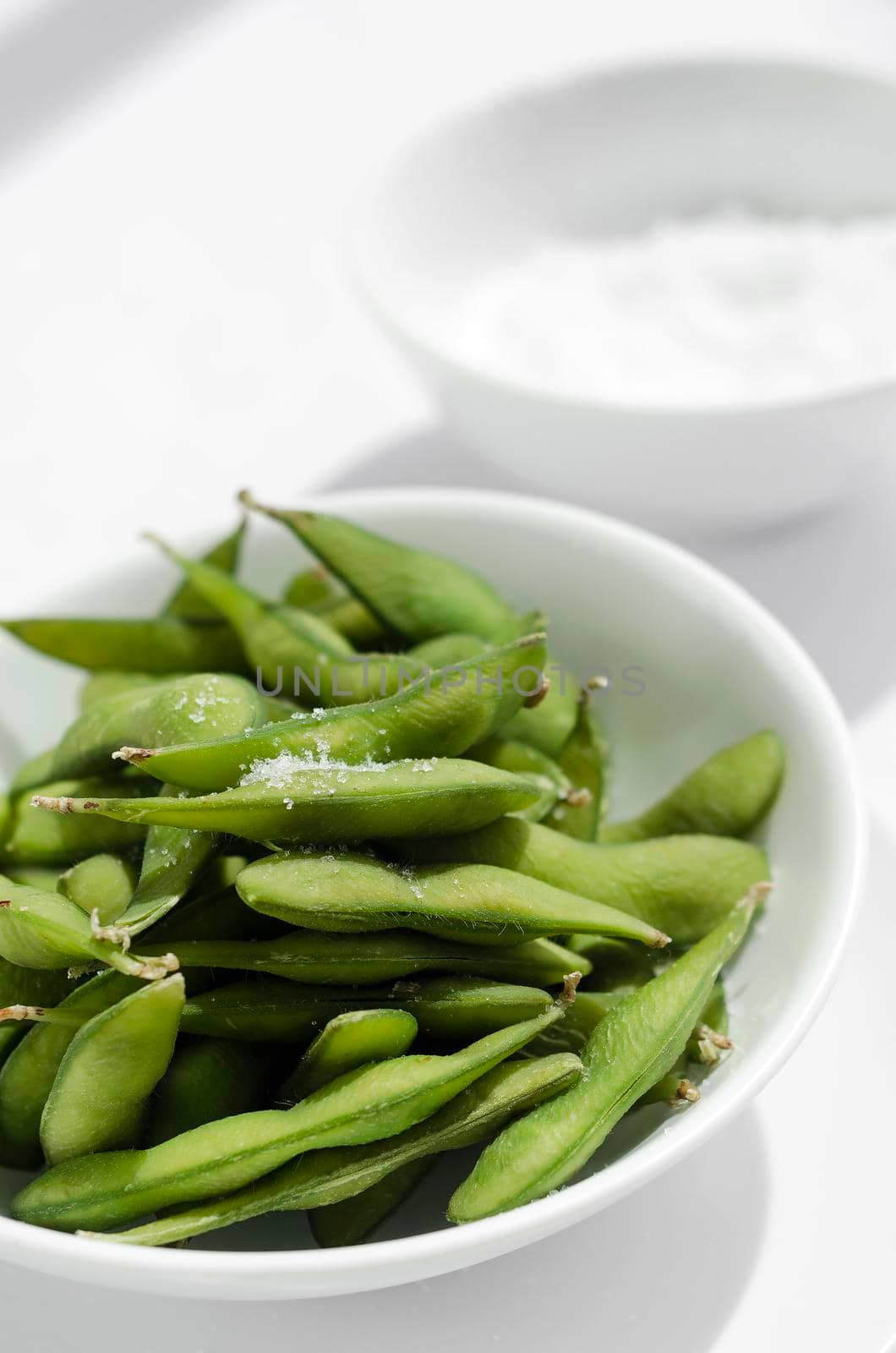 organic edamame beans snack in bowl on table with sea salt