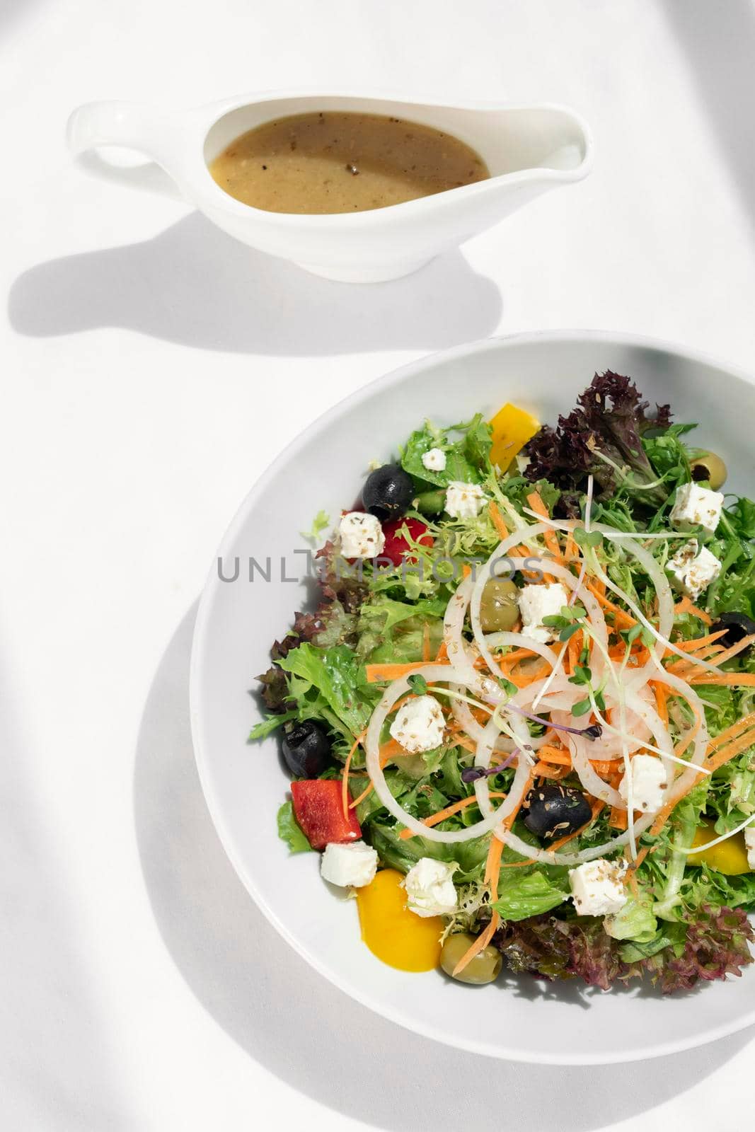 greek salad with feta cheese and olives with citrus vinaigrette by jackmalipan