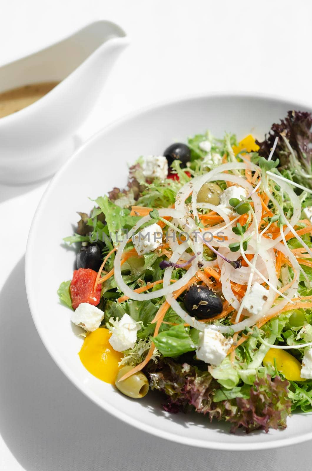 greek salad with feta cheese and olives with citrus vinaigrette by jackmalipan