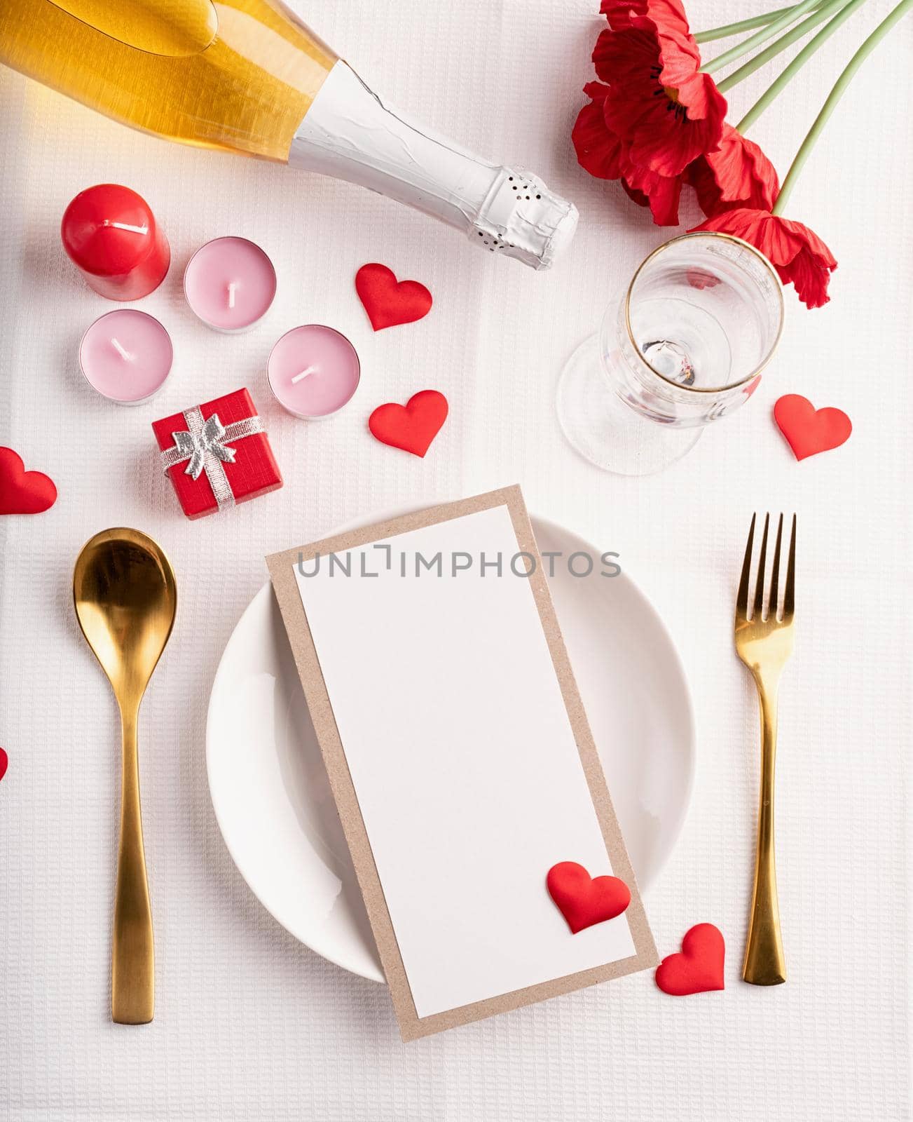 Valentines day table setting with menu, plate, bottle of champagne top view, mock up design by Desperada