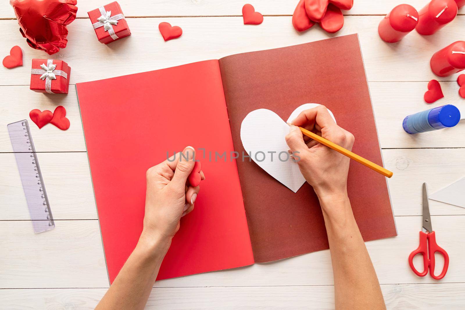 Valentines Day craft DIY. Step by step instruction making paper heart shape hot air balloon. Step 3 - use the heart template to draw three hearts on colored paper