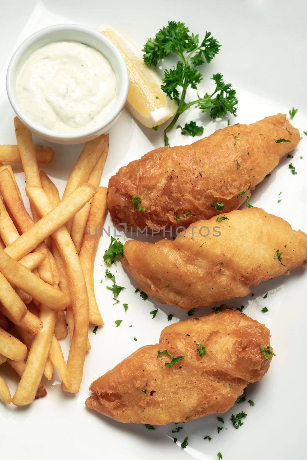 british traditional fish and chips meal on white plate