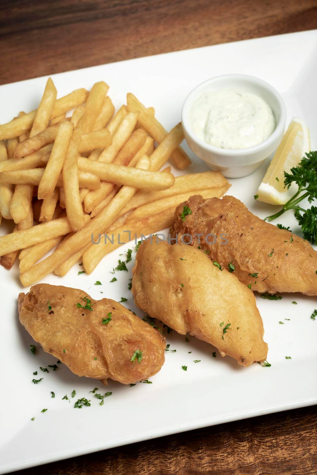 british traditional fish and chips meal on wood table