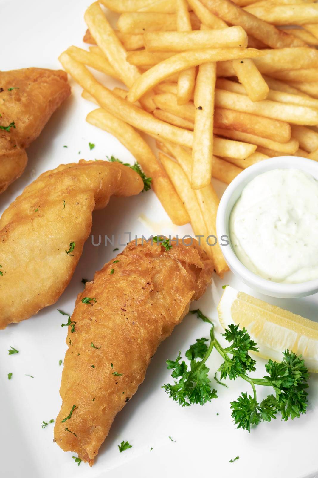 british traditional fish and chips meal on white plate