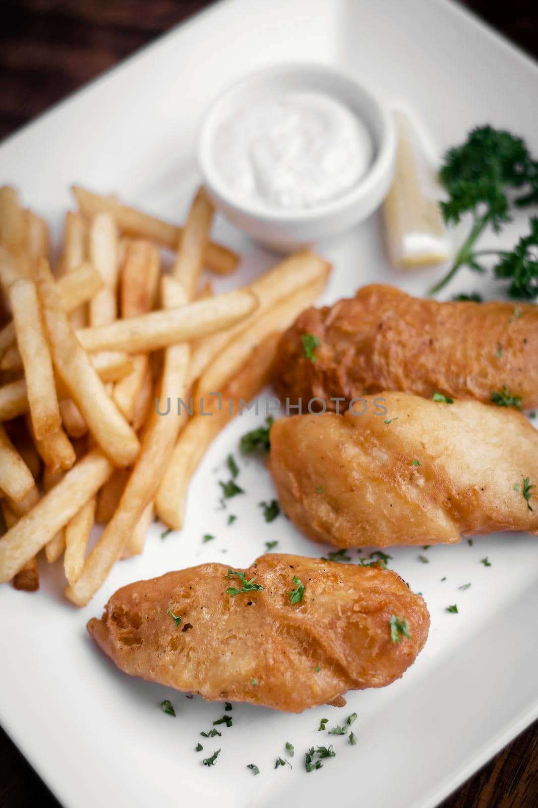 british traditional fish and chips meal on white plate
 by jackmalipan