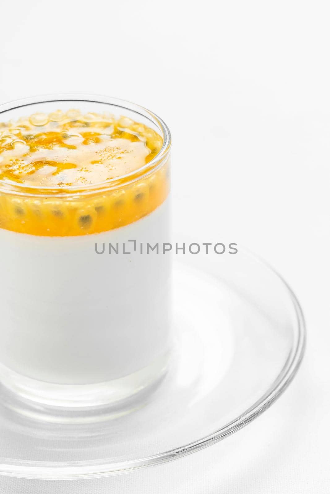 vegan dairy free organic coconut cream panna cotta with passion fruit dessert on white background