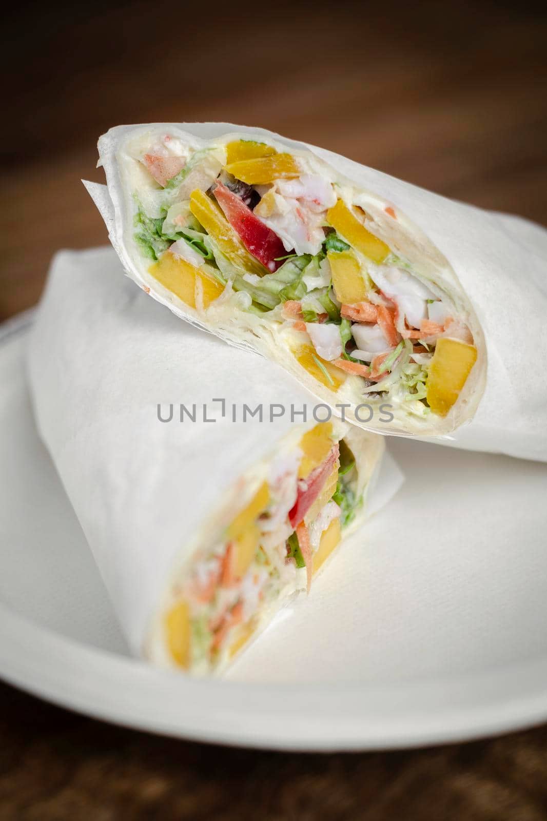 crab mayonnaise and salad wrap on wooden table background