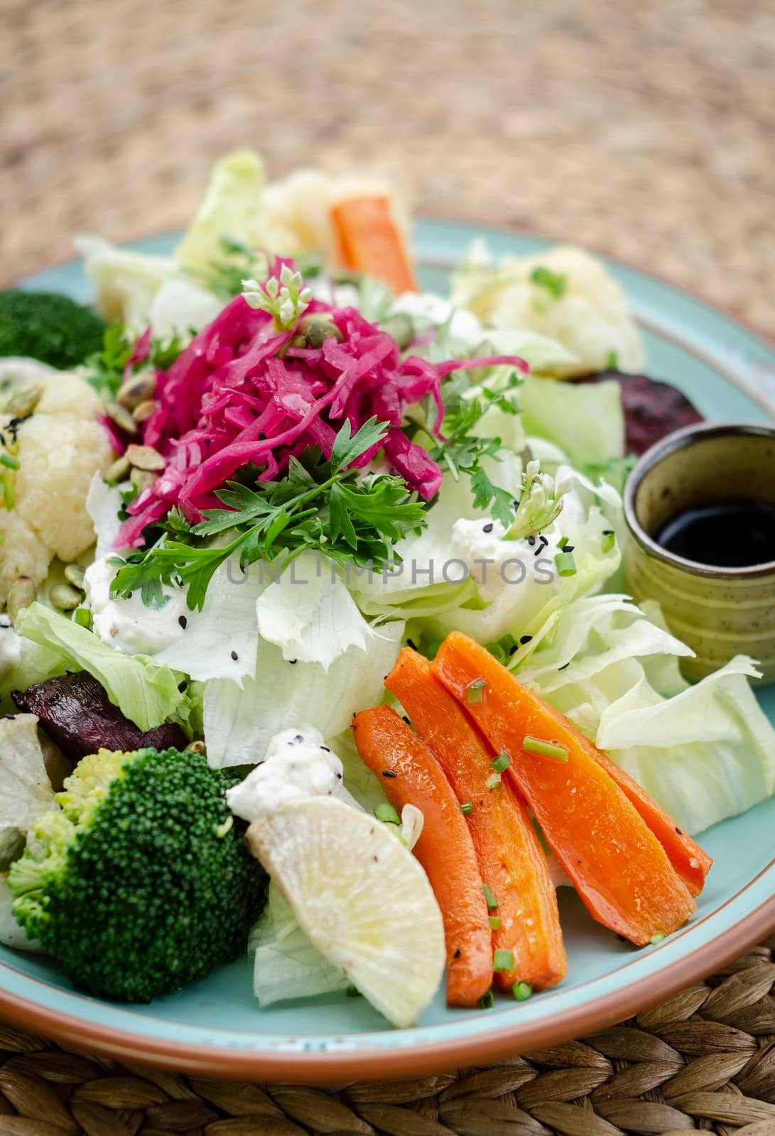 rustic cottage salad with healthy mixed steamed and fresh vegetables on colorful plate