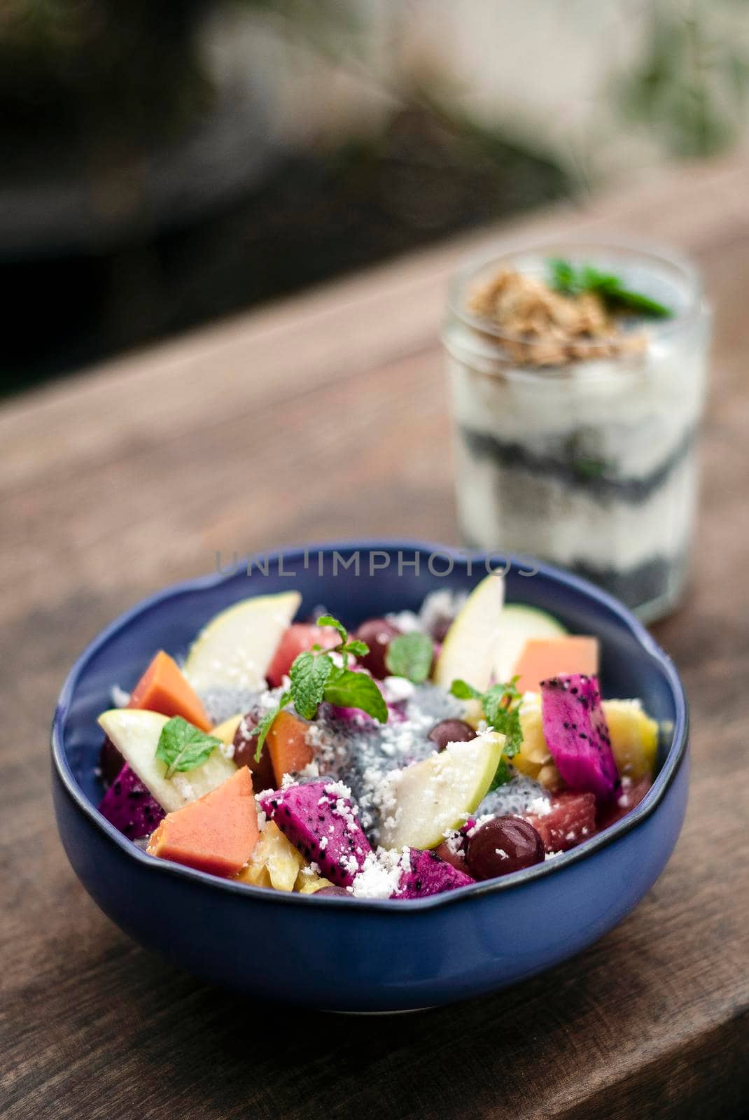 exotic mixed tropical asian fruit salad in bowl outdoors by jackmalipan