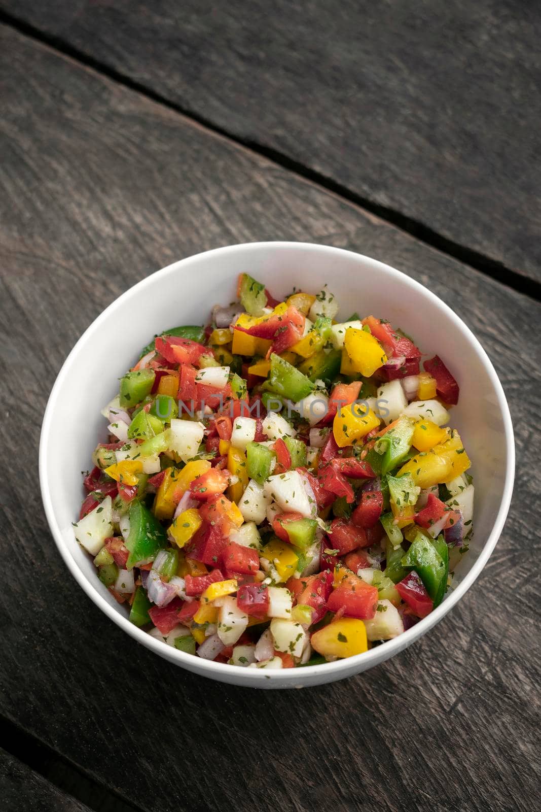 bowl of organic salsa salad on rustic old wood backgrond