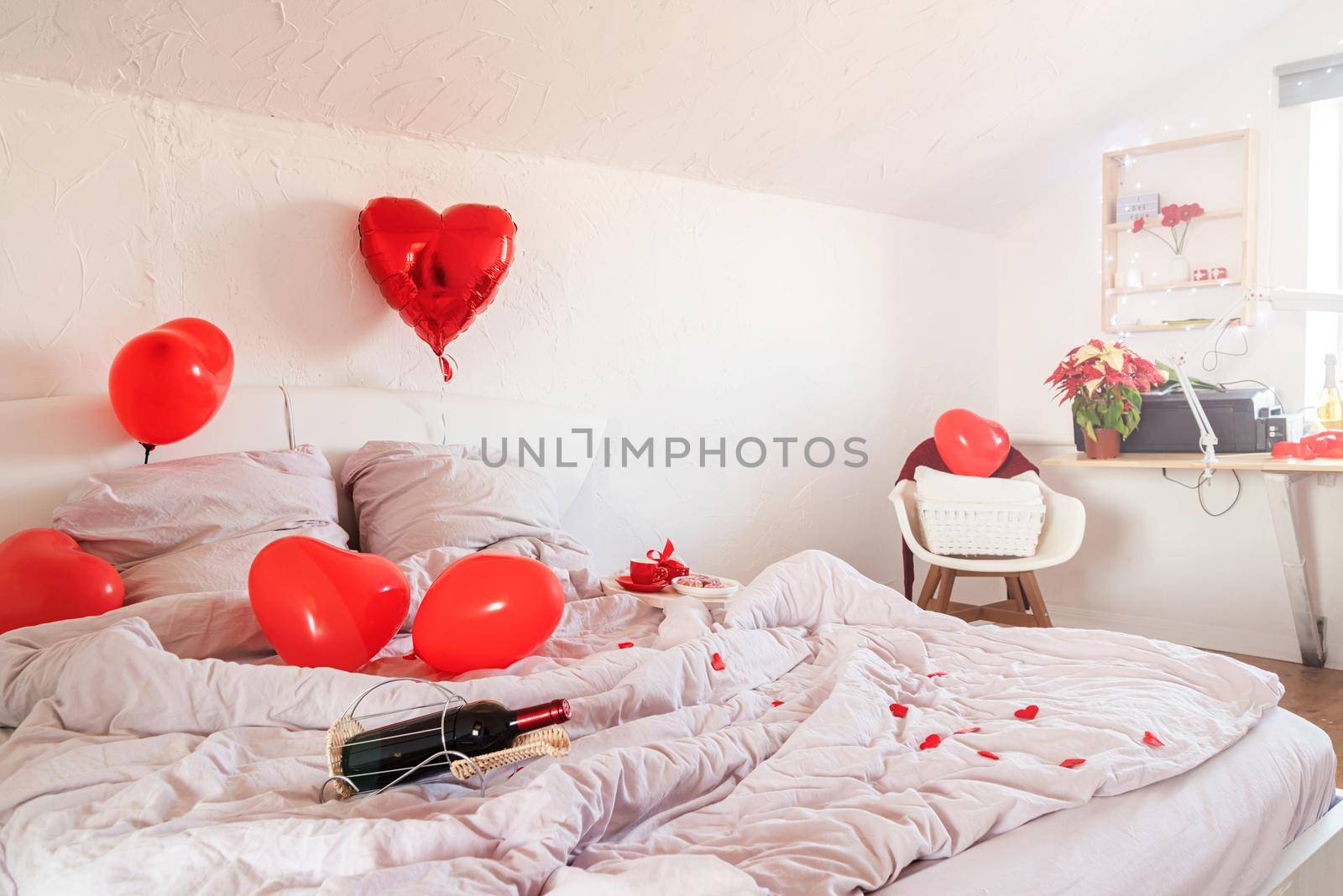 white romantic Valentine's Day bedroom with red hearts baloons