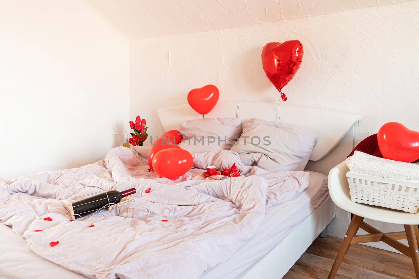 white romantic Valentine's Day bedroom with red hearts baloons