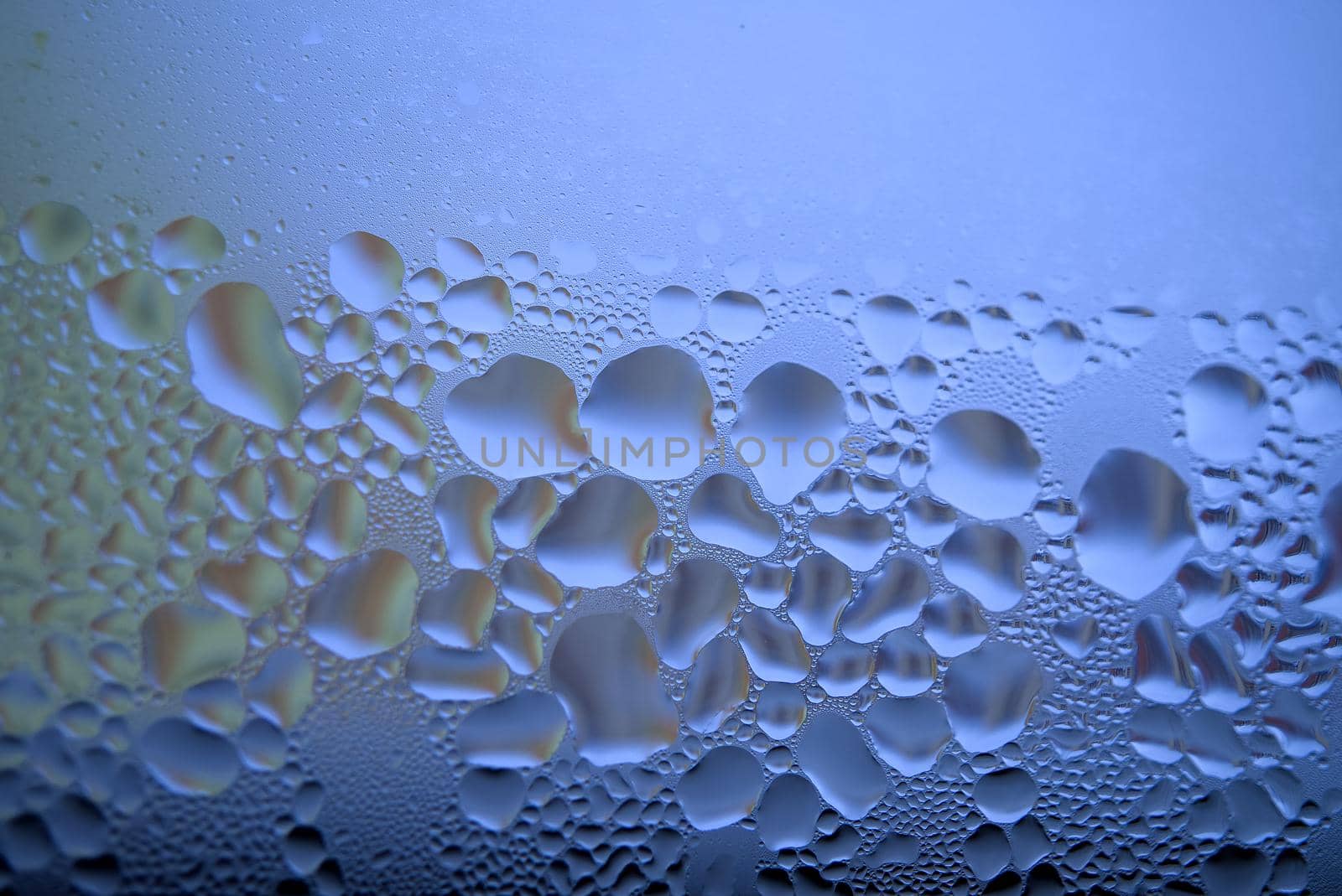 Water droplets or condensation on the outside of a cold windows in a close up full frame background texture