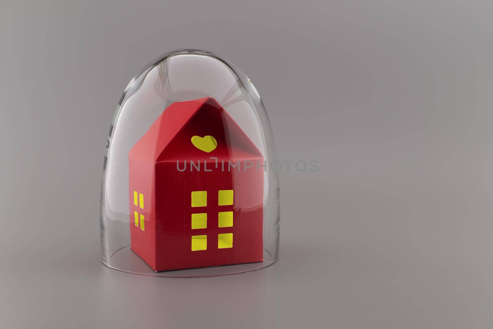 Red building with lights in the windows under protective shield as a concept of covid pandemic and self-isolation