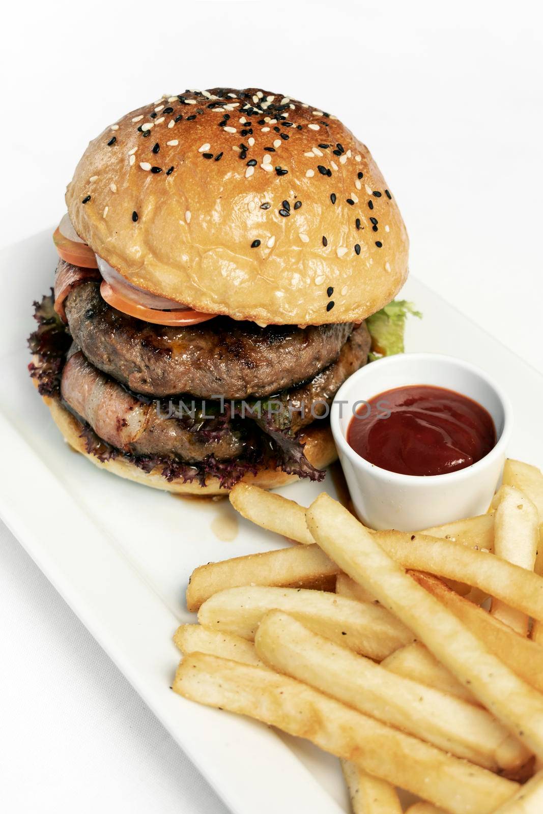 australian organic beef burger with french fries platter on white studio background