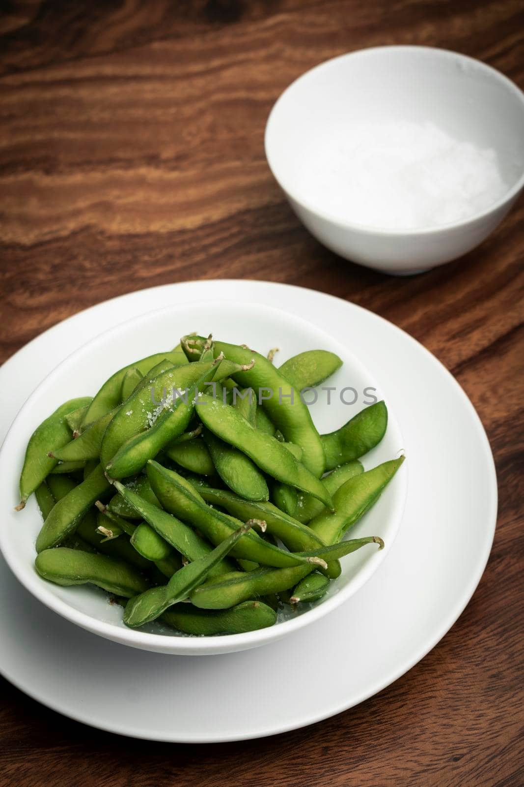 organic edamame beans snack in bowl on table with sea salt