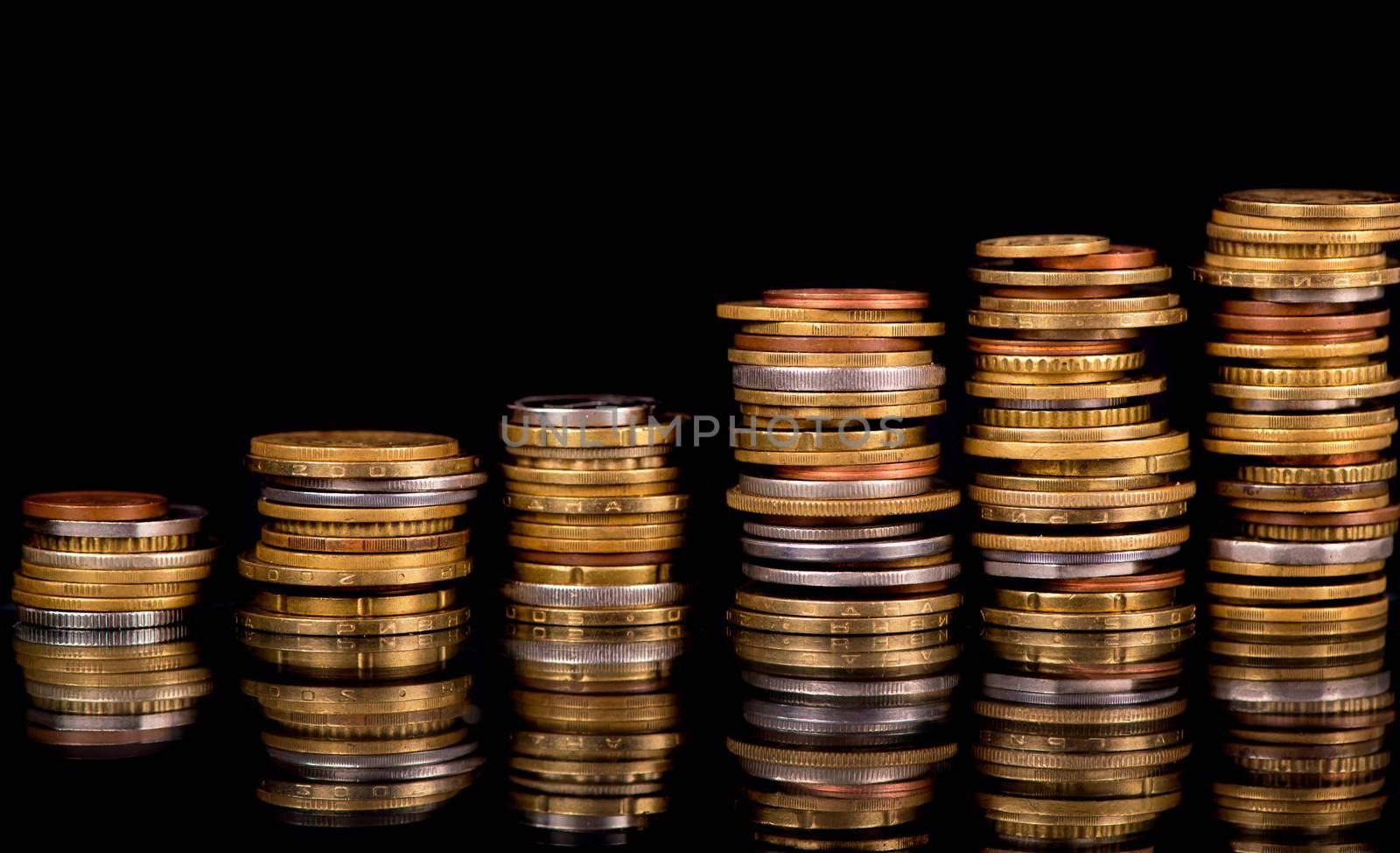 Stack Coins Over Black Background by aprilphoto