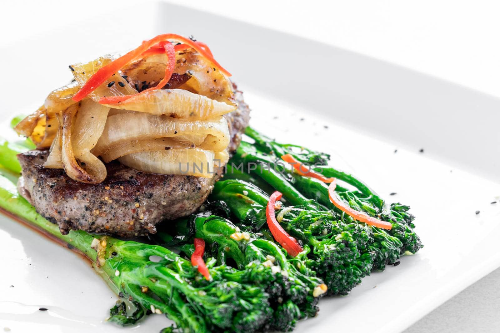 beef steak with caramelized onions and broccoli gourmet restaurant meal by jackmalipan