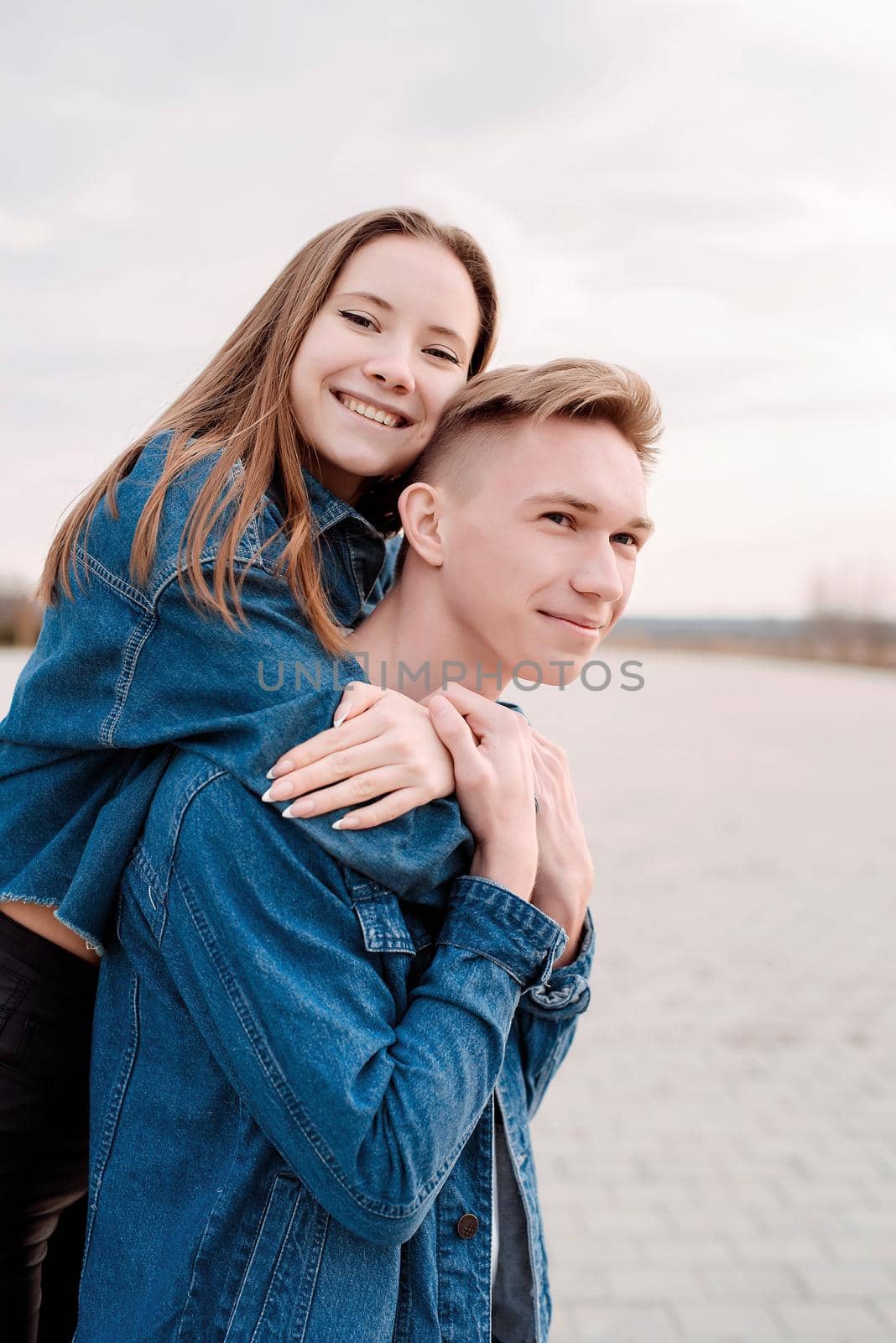 Young loving couple embracing each other outdoors in the park by Desperada