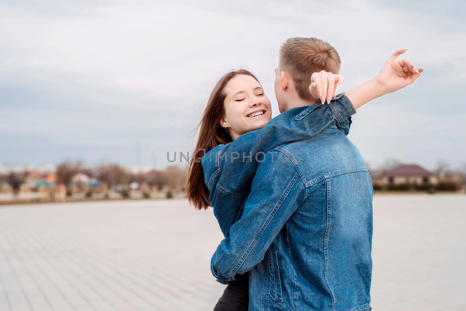 Young loving couple embracing each other outdoors in the park by Desperada