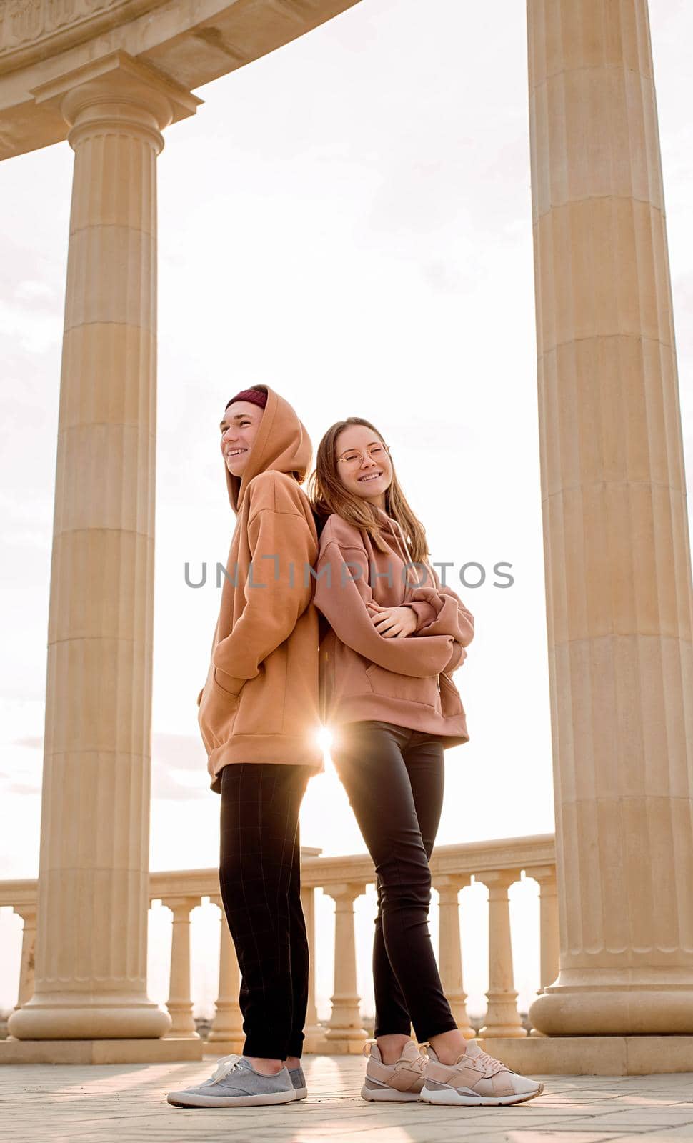 Young hipster couple or friends standing together outdoors in the park
