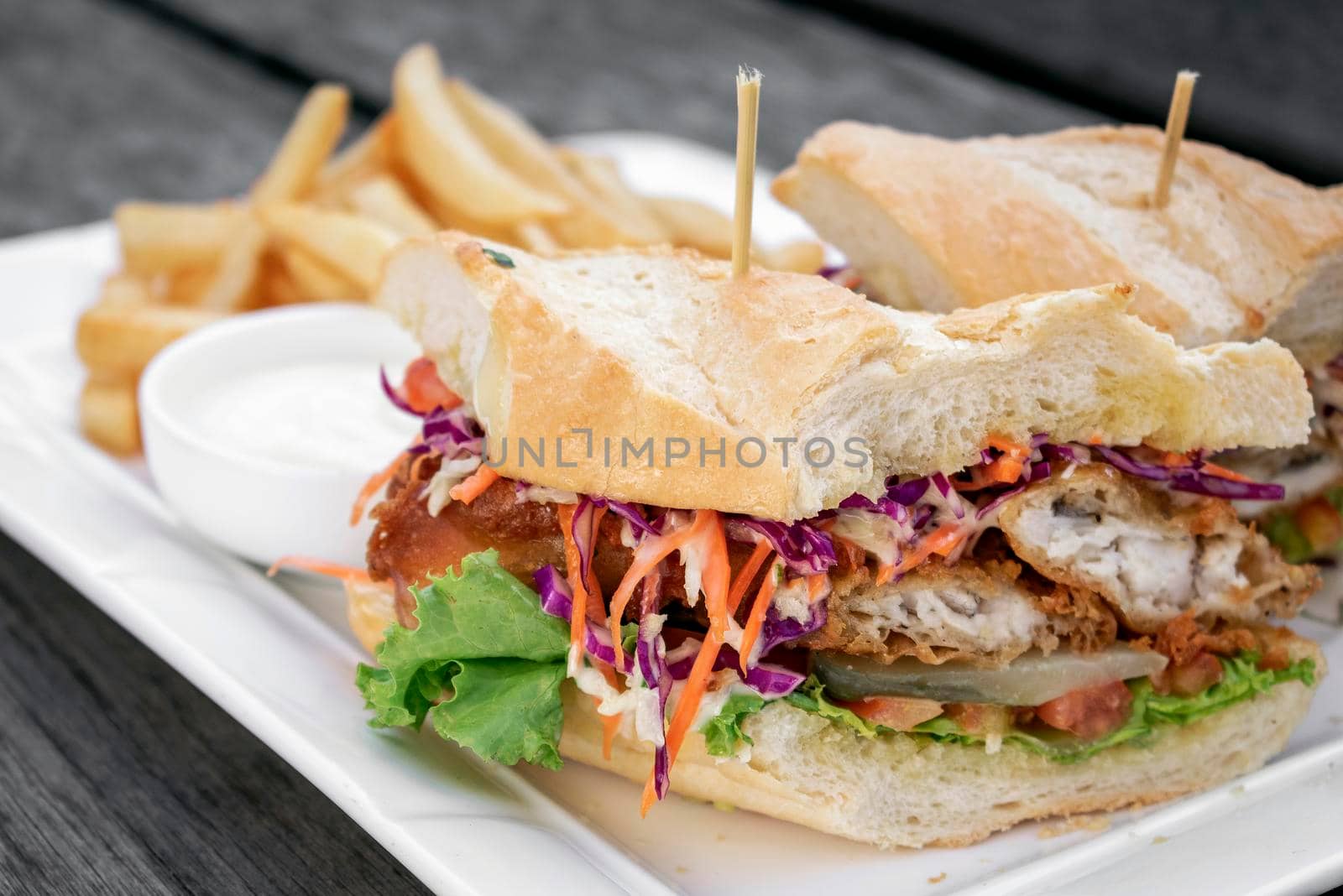 fried battered fresh fish fillet sandwich with coleslaw salad french fries and tartar sauce