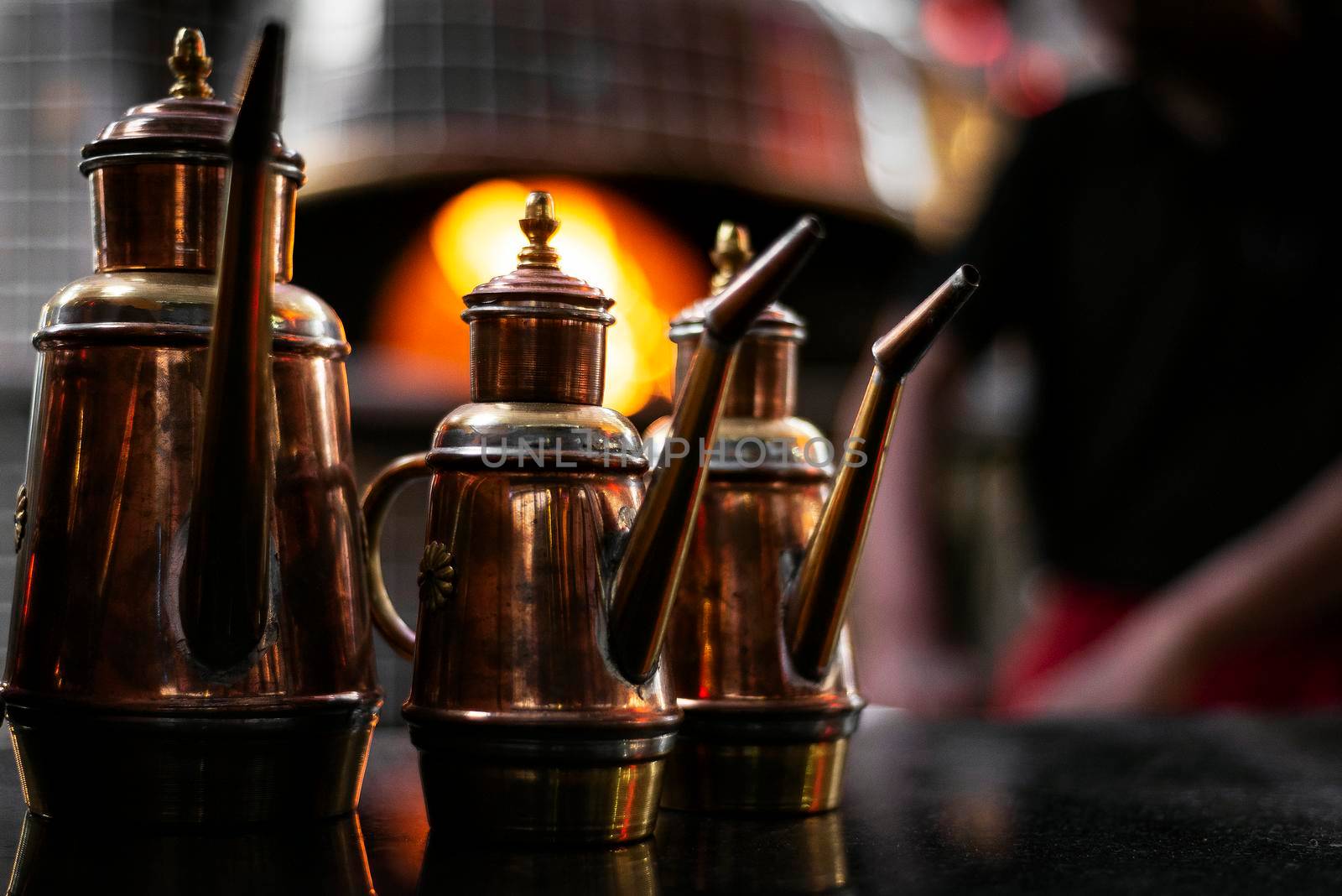 olive oil copper cruet traditional dispenser detail in italian restaurant by jackmalipan