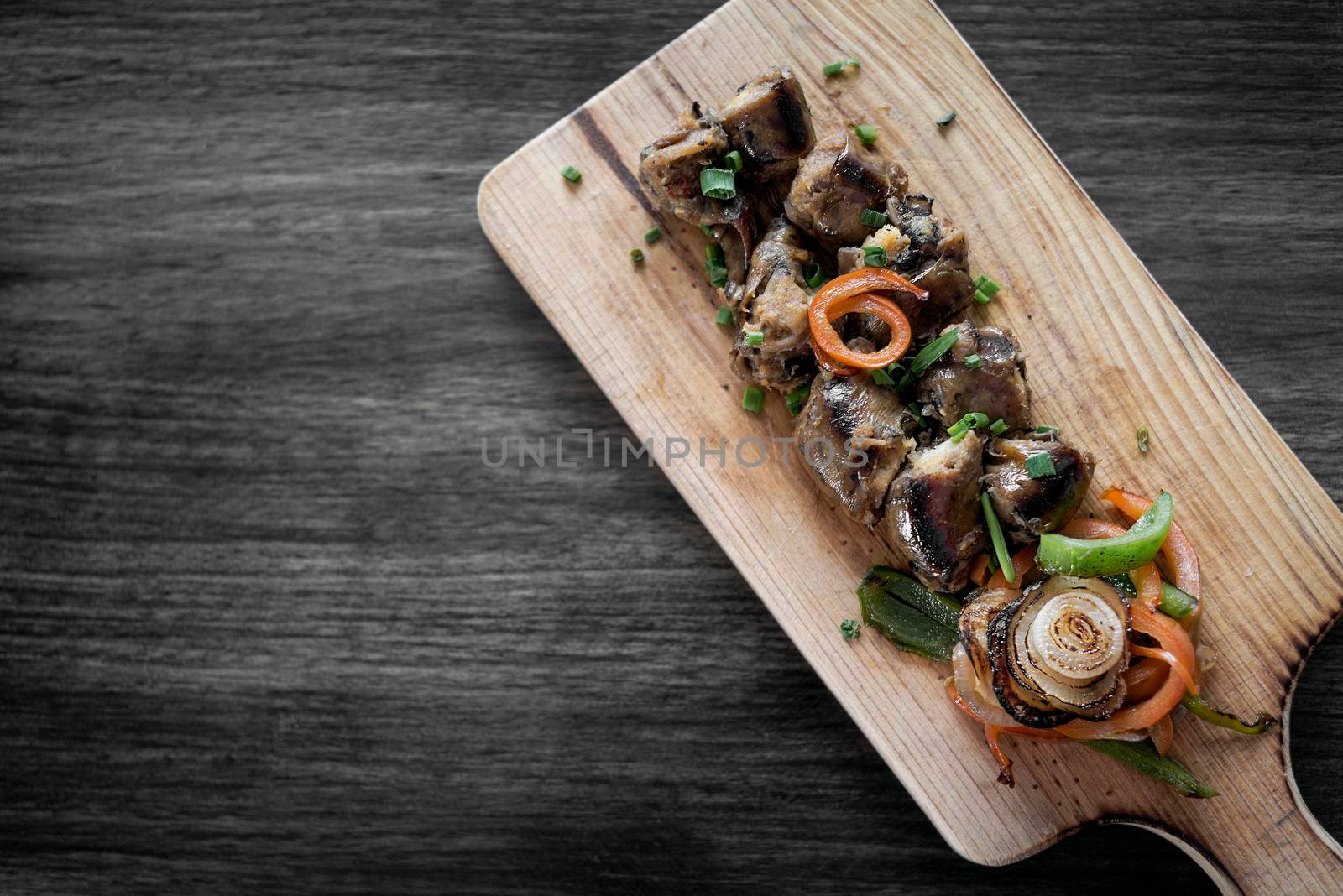grilled fresh sausage starter tapas snack set on rustic wood board