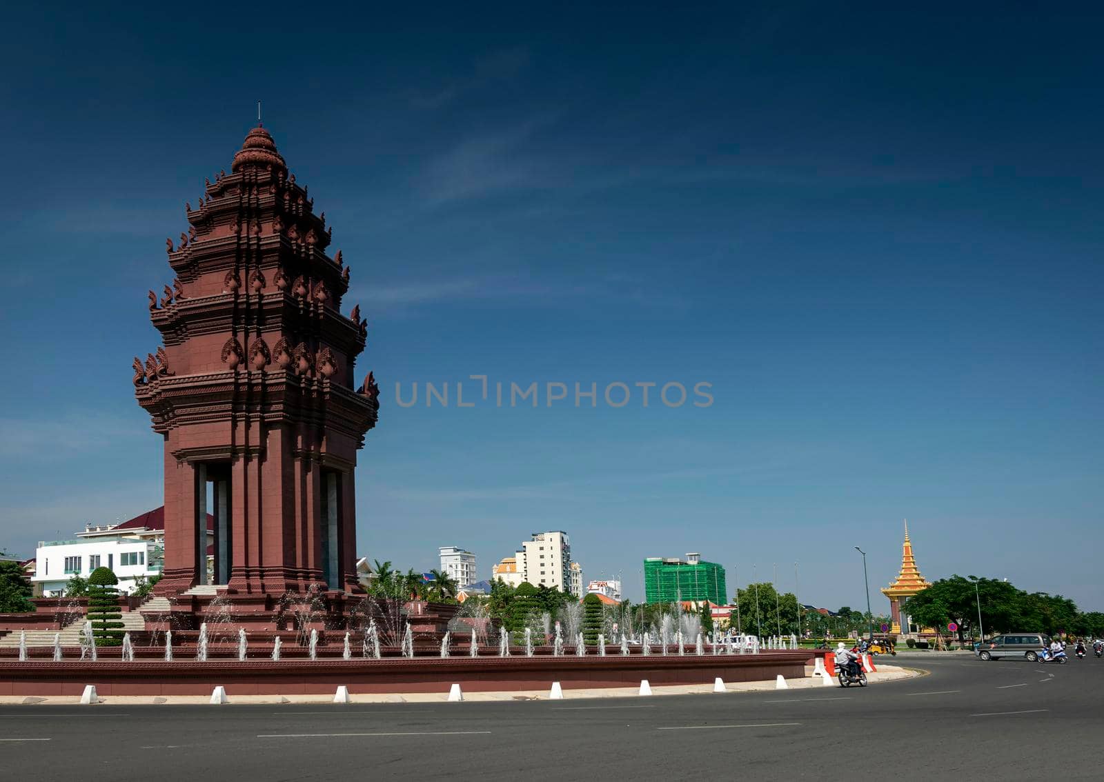 independence monument landmark on central downtown phnom penh city street in cambodia on sunny day