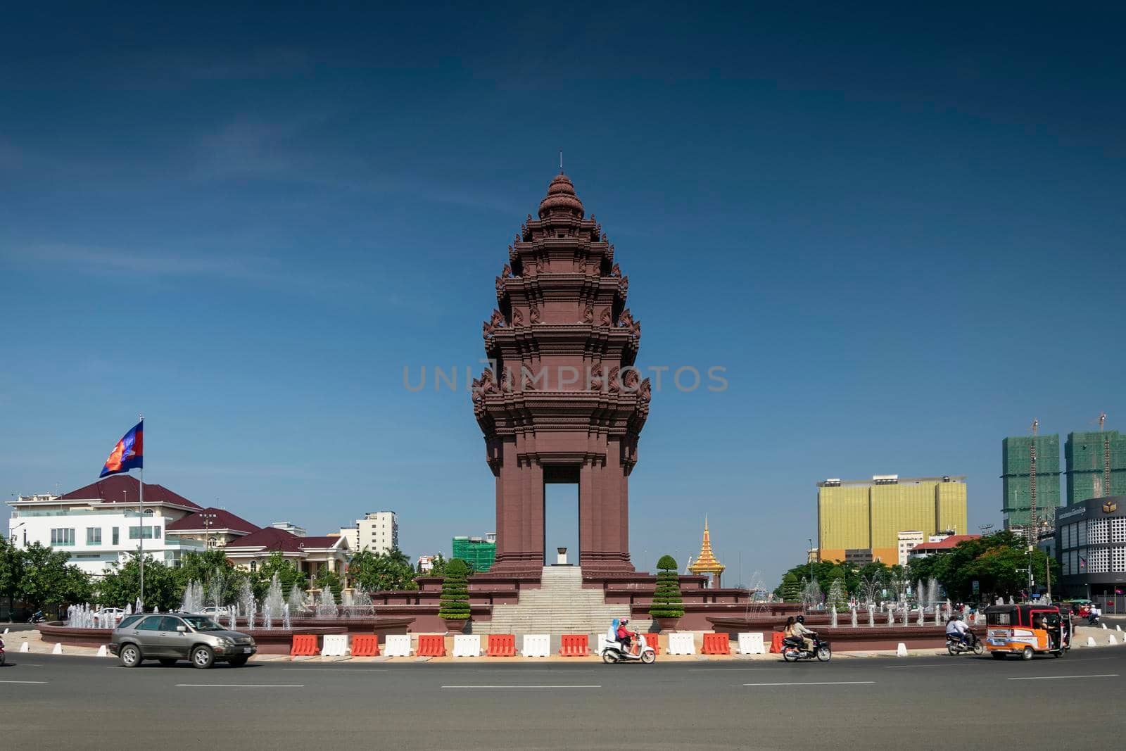 independence monument landmark on central downtown phnom penh city street in cambodia on sunny day