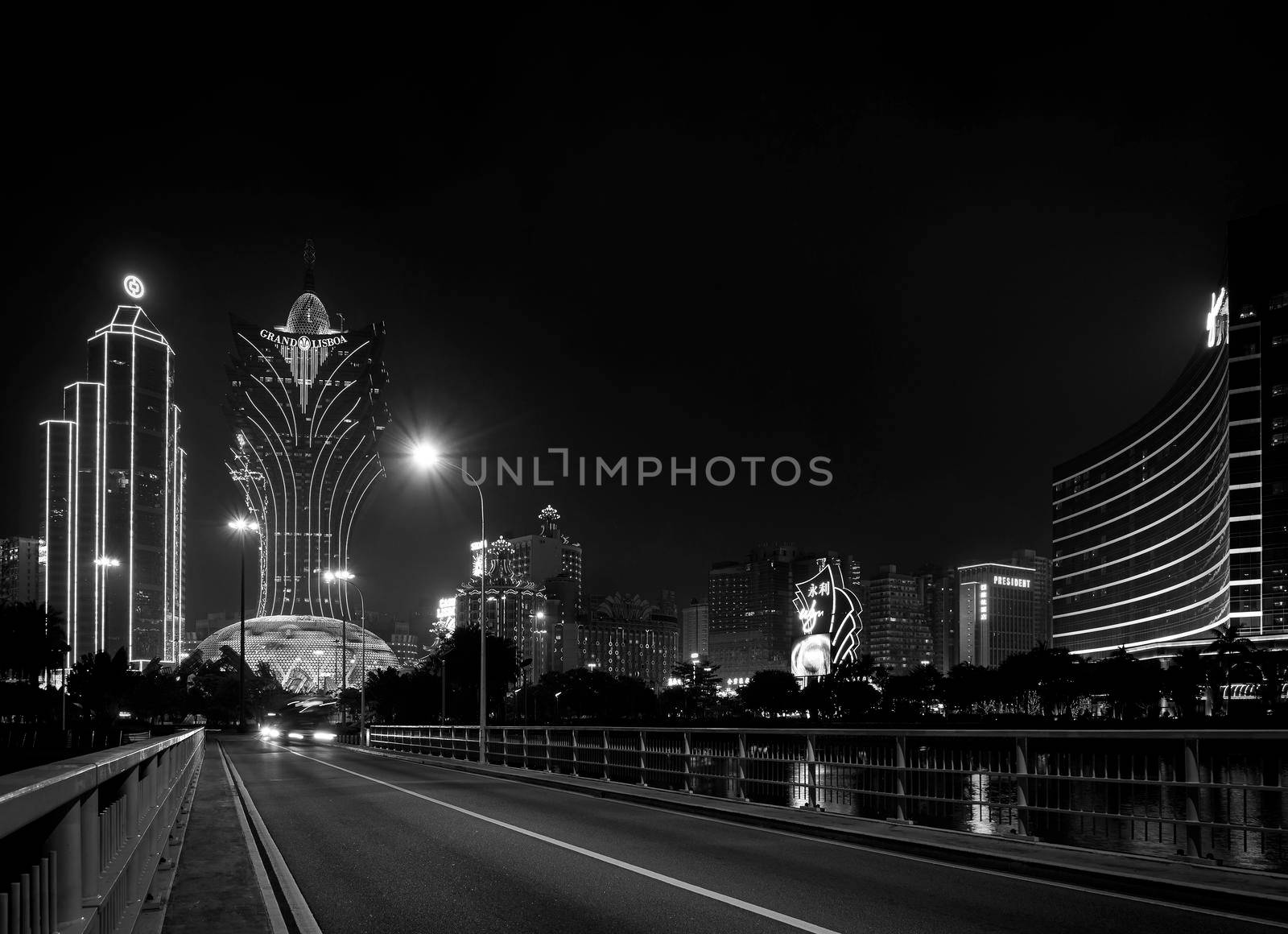 view of casino buildings at night in macau city china by jackmalipan