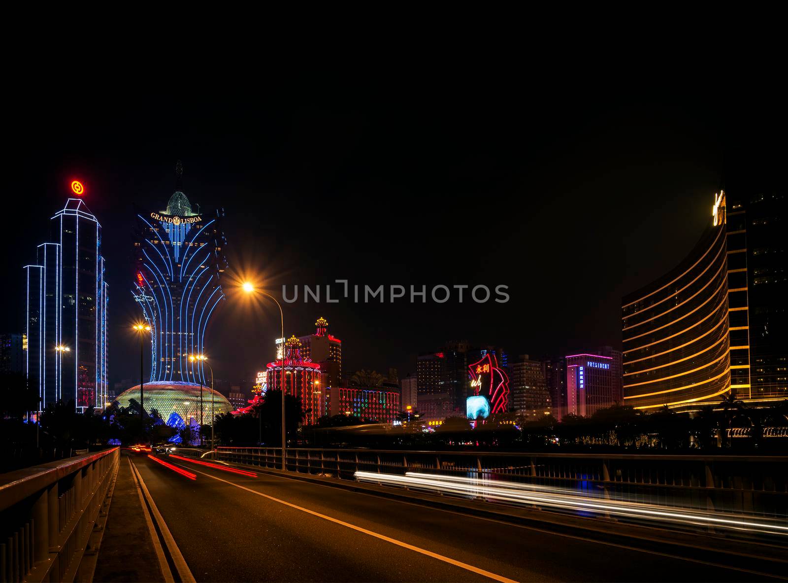 view of casino buildings at night in macau city china by jackmalipan