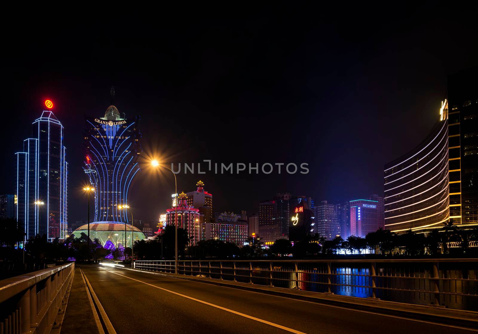 view of casino buildings at night in macau city china by jackmalipan