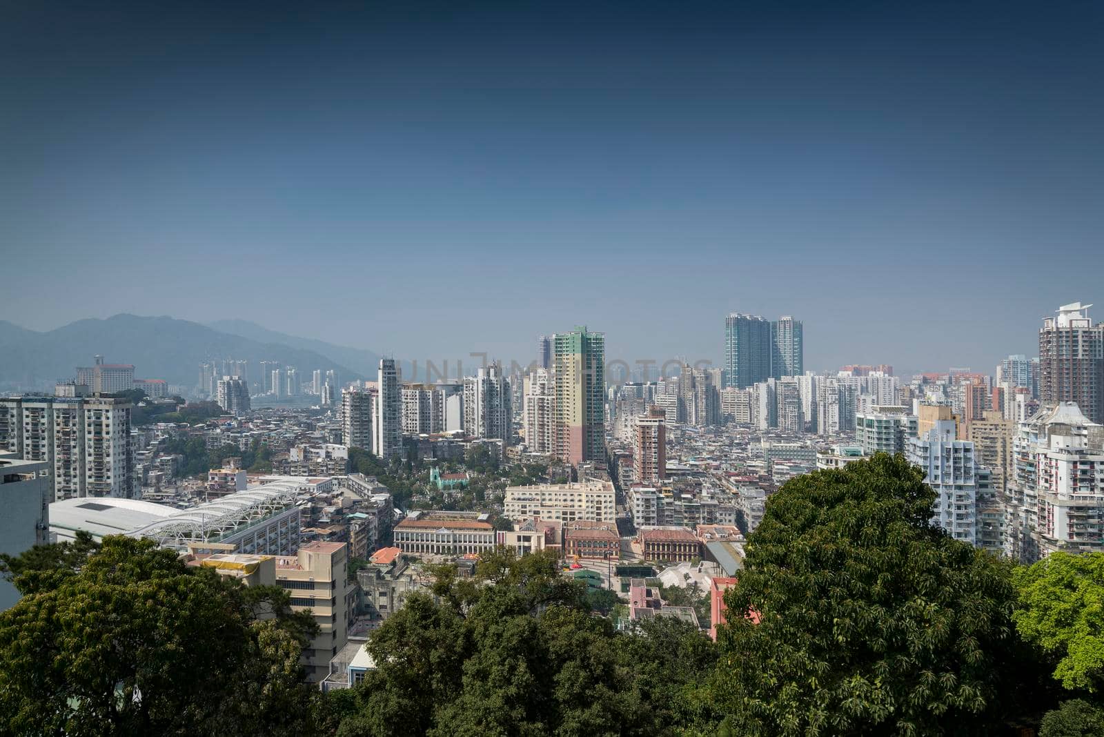 urban skyline view with tower blocks in central macau city by jackmalipan