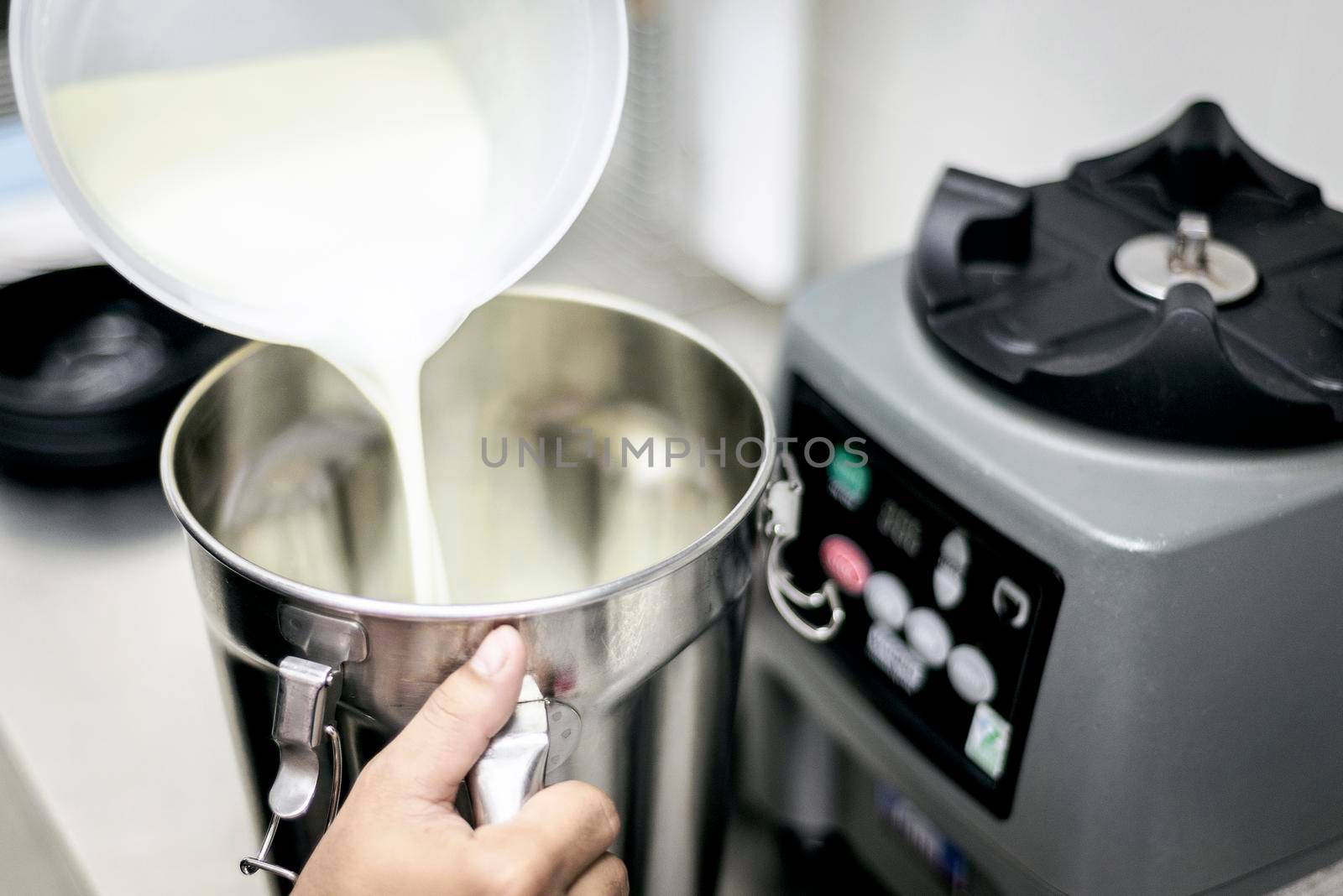 making gelato ice cream with modern professional equipment preparation detail in kitchen interior