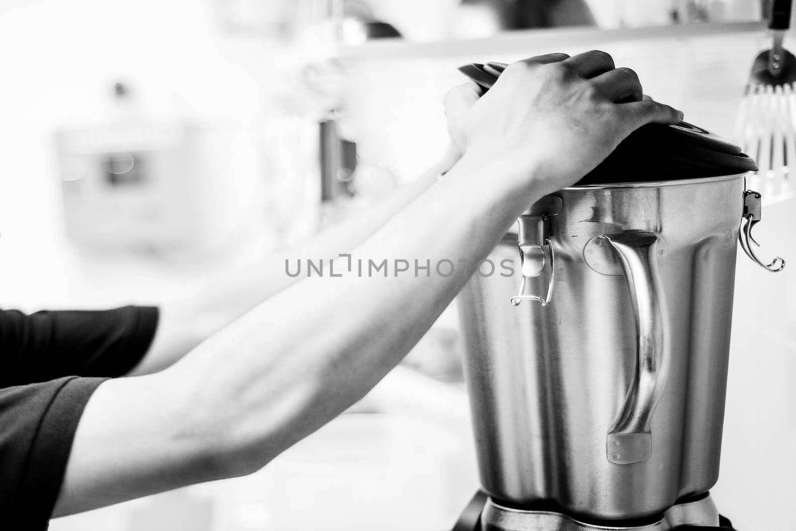 making gelato ice cream with modern professional equipment preparation detail in kitchen interior black and white photo