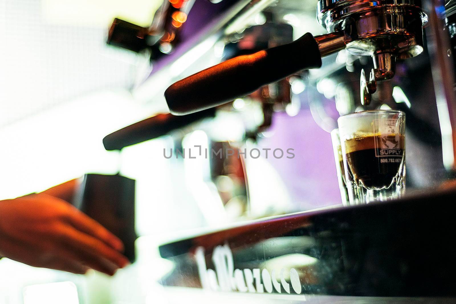 making espresso coffee close up detail with modern machine by jackmalipan