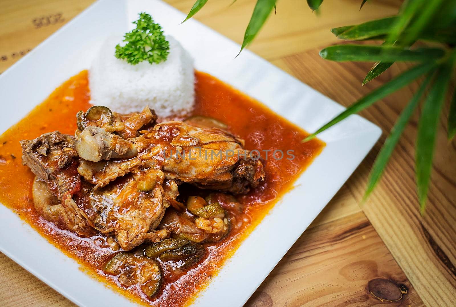 basque style chicken and vegetable stew meal on wooden table by jackmalipan